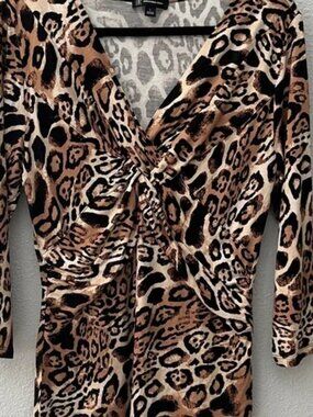 INC Animal print stretch top.  
V-neck twist
Long Sleeve
Woman’s 
Sz L